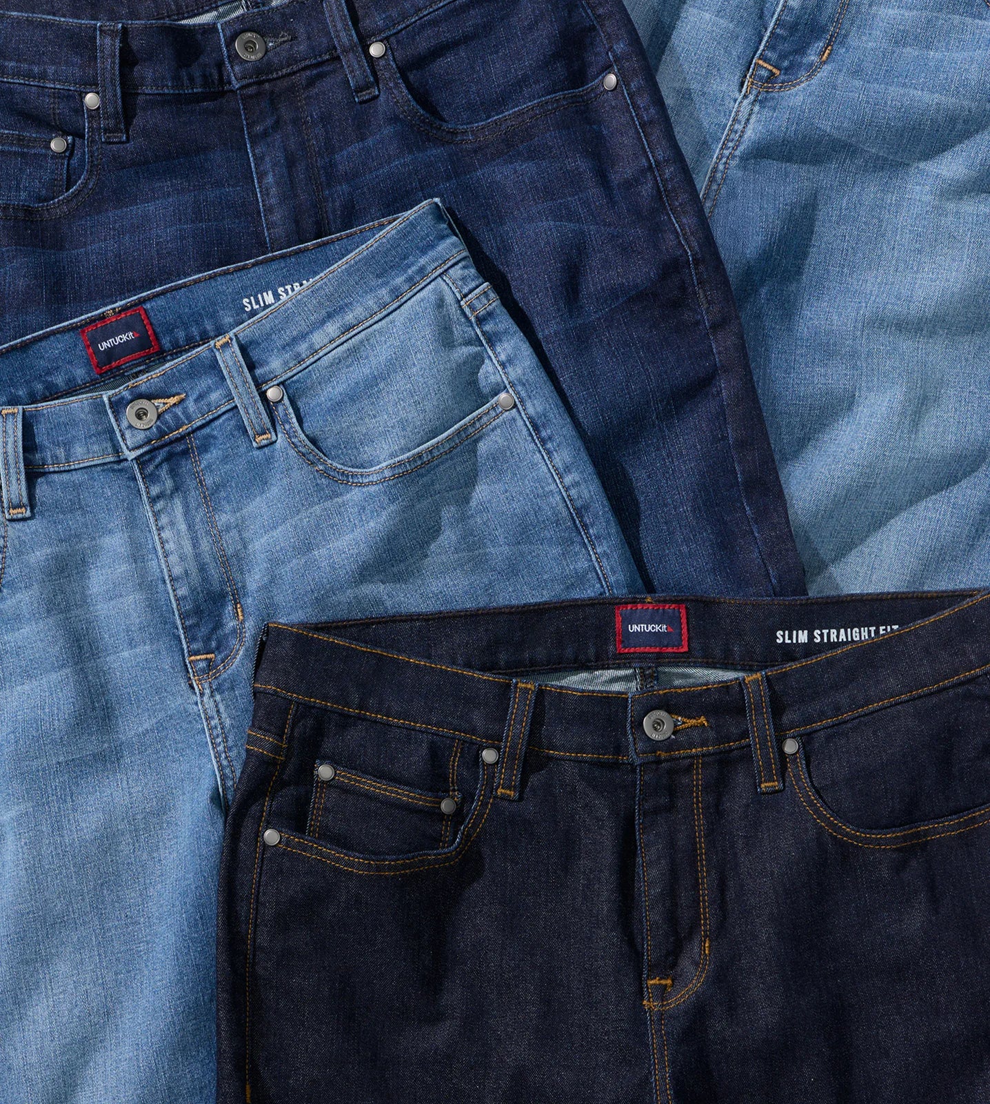 Various styles of denim jeans in different shades of blue.